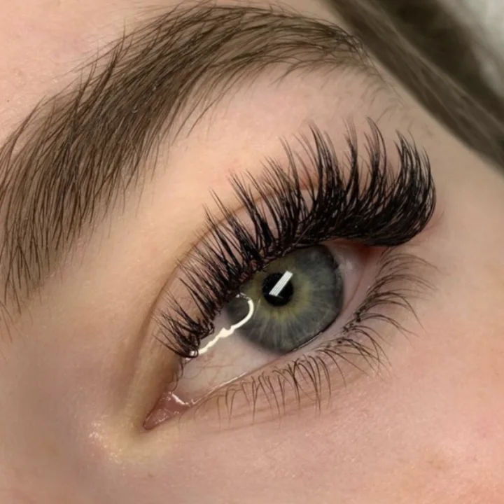 Close-up of a wet-look lash set with narrow, defined spikes